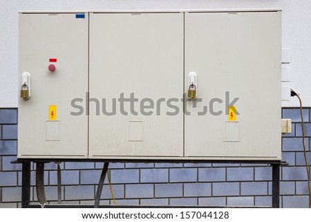 electrical cabinet with warning signs and padlocks at a street