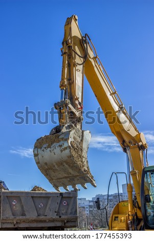 excavator arm and dumper truck digging trench for sewer line excavator arm and dumper truck digging trench for sewer line