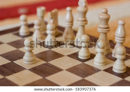 White make the first move in chess. Chess pieces on a table in the room, wood Chess Set
