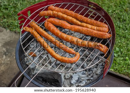 Preparing Sausage on Outdoor Grill. Selective focus.