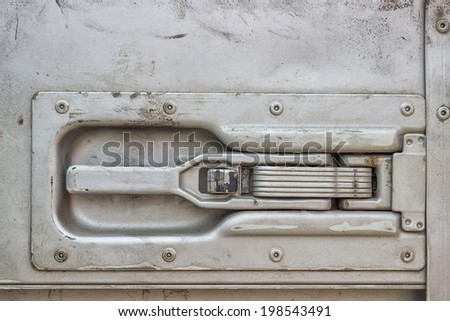 Truck trailer door handle. Handle allows for easy opening and closing. Detail of a truck door.