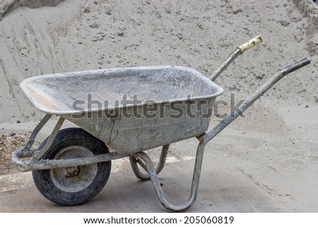 Classical concrete trolley, cement wheelbarrow after work