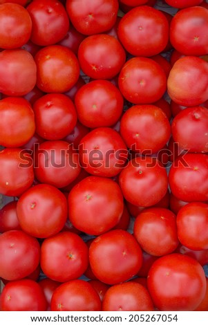Farmers market tomato  in a wooden crates,  background. At the farmers market local growers come and sell their freshly picked crops at reasonable prices. Selective focus.