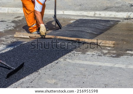 City crew install a new speed bump for slowing traffic near school. Selective focus.