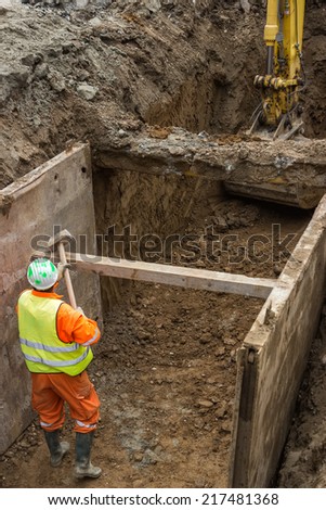 working on trench construction, underground installation by open trench method