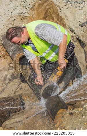 BELGRADE, SERBIA - OCTOBER 01: Close of cutting section of water main pipe for installation new valve. Teeing into a water main. At street Vojvode Stepe in October 2014.