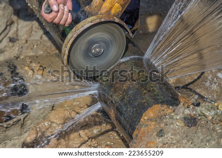 close of cutting section of water main pipe for installation new valve. Teeing into a water main. Selective focus.