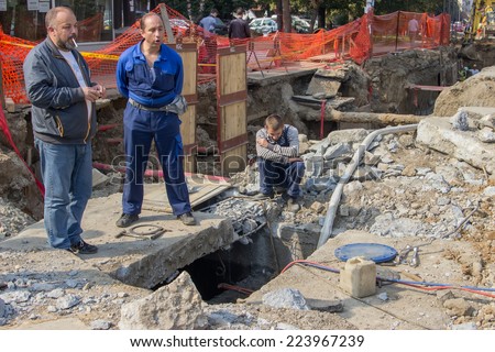 BELGRADE, SERBIA - OCTOBER 01: Utility crew fixing broken water main. Teeing into a water main. At street Vojvode Stepe in October 2014.