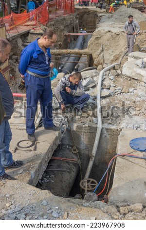 BELGRADE, SERBIA - OCTOBER 01: Utility crew fixing broken water main. Teeing into a water main. At street Vojvode Stepe in October 2014.