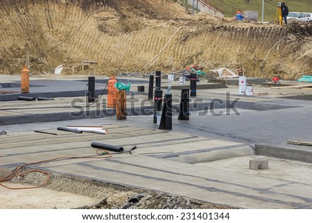 BELGRADE, SERBIA - OCTOBER 30: Foundation waterproofing, insulation concrete slab. Applying the tar coating on concrete slab. At construction site in October 30, 2014.