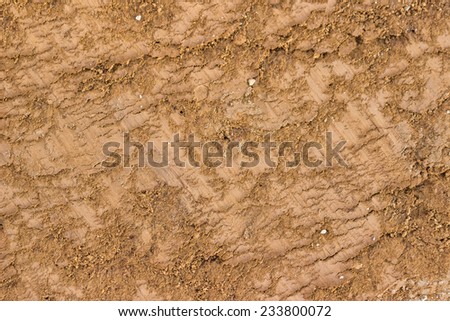 Ground texture background, with small rocks and dust. Excavation dirt texture exposed.