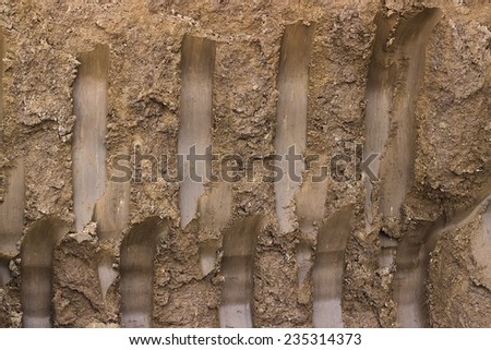 Ground texture background, with small rocks and dust. Excavation dirt texture exposed.