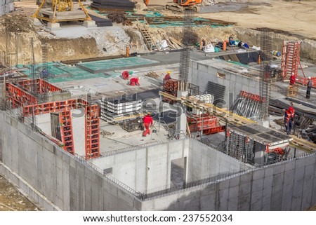 BELGRADE, SERBIA - NOVEMBER 11: Bird view of concrete foundation with reinforcement rods and workers. At construction site in November 2014.