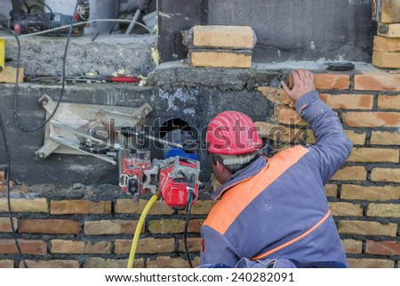 BELGRADE, SERBIA - DECEMBER 24: Wet coring work,  drilling penetration on concrete wall for pipe. Selective focus. At construction site in December 2014.