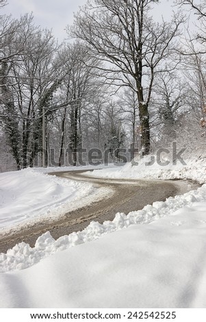 Dangerous double curve on the winter road. Dangerous road at winter.