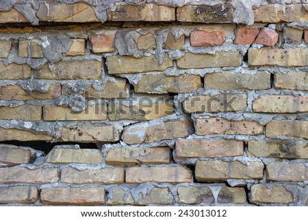 Broken brick wall background. Cracked brick wall.