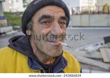 BELGRADE, SERBIA - DECEMBER 28: Builder worker with cigaret, cigarette smoke break. Selective focus. At construction site in December 2013.