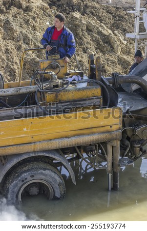 BELGRADE, SERBIA - FEBRUARY 16: Operators on concrete pump truck for placing concrete into formwork. At construction site in February 2015.