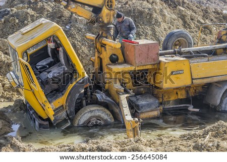 BELGRADE, SERBIA - FEBRUARY 19: Concrete pump truck is stuck in the mud and water. Truck stuck in mud. At construction site in February 2015.