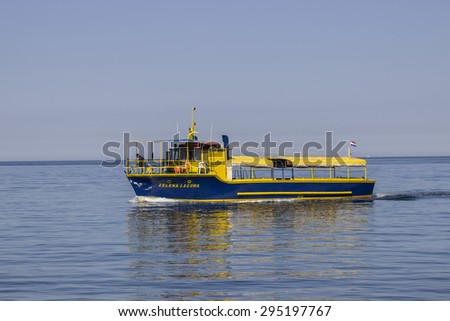 POREC, CROATIA - JULY 02: Ferry service ship entering in port to take passengers. Local water taxi for travel concept in July 2015.