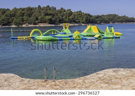 POREC, CROATIA - JULY 02, 2015: Water inflatable jumping castle.  Water bouncy park. Inflatable water park.