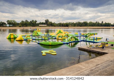 BEOGRAD, SERBIA - AUGUST 23, 2015: Water inflatable jumping castle on artificial Lake Ada Ciganlija. Water bouncy park. Inflatable water park. Made with shallow depth of field.