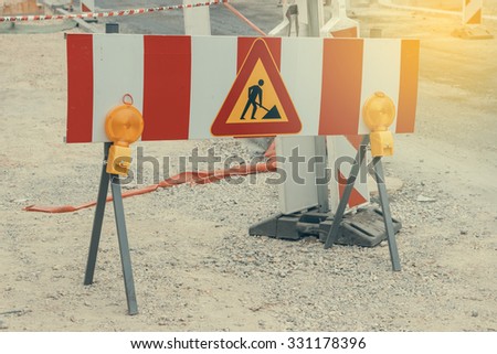 Road under construction with warning signs. Work in progress, road closed sign. Vintage filter.