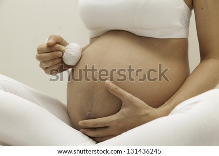 Spa woman eight months pregnant belly while health care