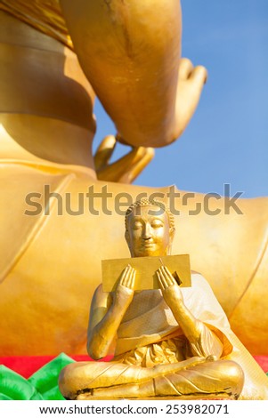 The statue in the back of the Buddha.