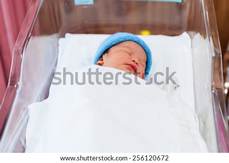 Newborn baby sleeping in the delivery room.