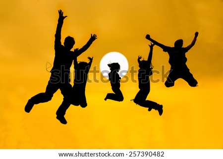 silhouette of friends jumping