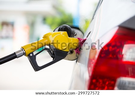 Yellow fuel nozzle at a gas station.