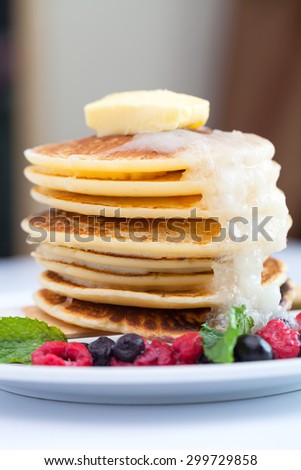 Mixed berry pancake on white plate.
