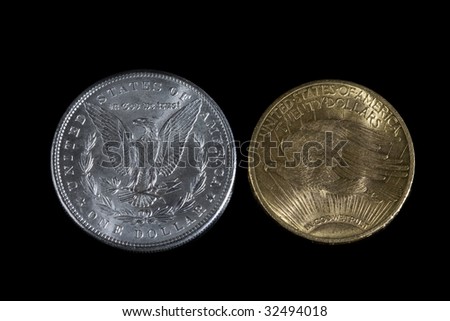 Morgan Silver Dollar and Saint Gaudens Gold Twenty Dollars.  Back (reverse) side showing on black background.