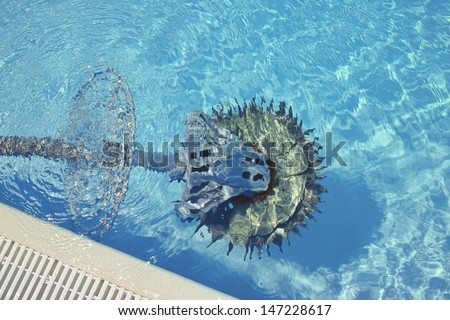 Swimming pool cleaner robot immersed in water