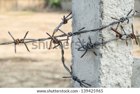 Concrete barbed wire fence post