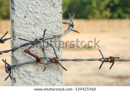 Concrete barbed wire fence post