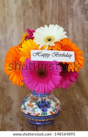 Happy Birthday card and colorful bouquet of gerbera daisies in vintage vase