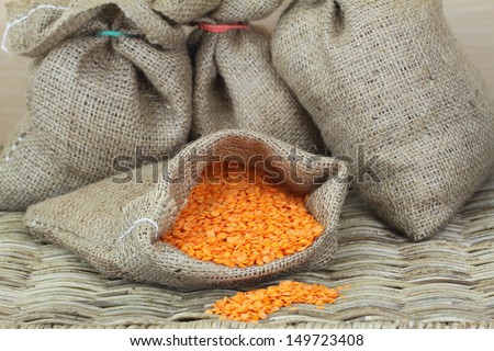 Red lentils in jute bag, close up