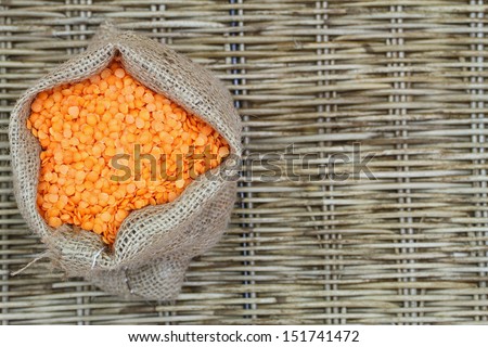 Red lentils in jute bag with copy space