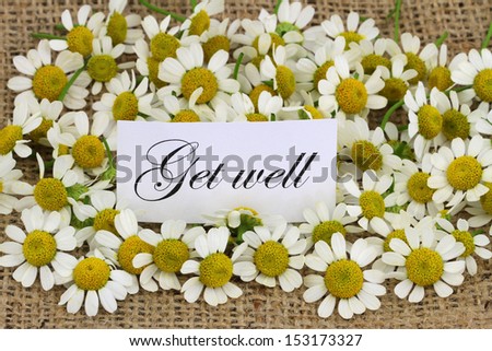 Get well card with chamomile flowers on jute surface