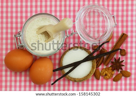 Selection of baking ingredients on pink checkered cloth