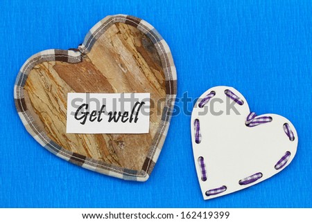 Get well card with wooden hearts on blue background