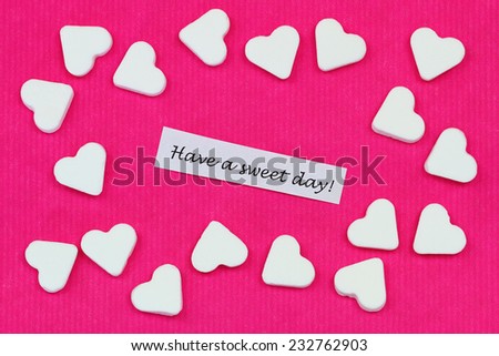 Have a sweet day with sugar hearts on pink surface