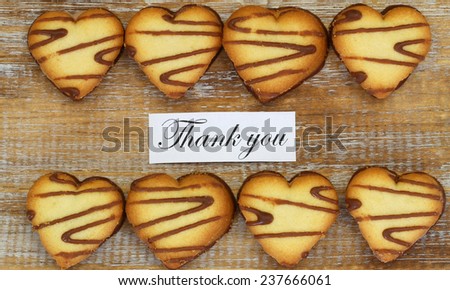 Thank you card with heart shaped cookies on rustic surface