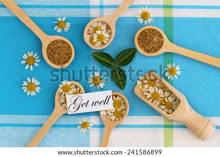 Get well card with dried chamomile herbs on wooden spoons