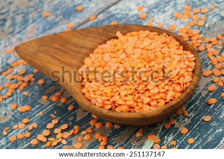 Uncooked red lentils in bamboo dish, closeup