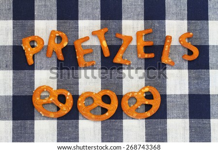 Word pretzels written with pretzel-like letters on checkered cloth