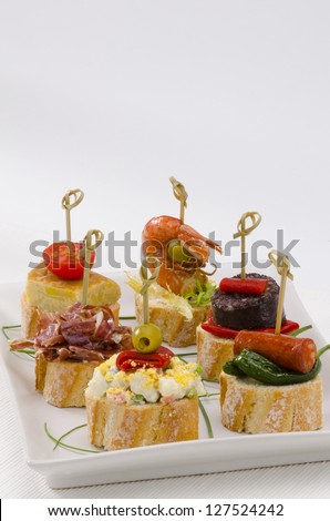 Spanish cuisine. Montaditos. Sliced bread topped with a variety of appetizers. Spanish Tapas.
