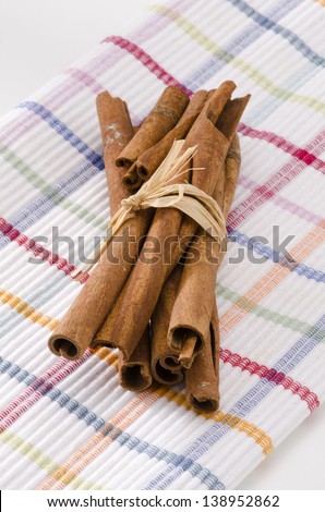 Cinnamon sticks in a bunch. Herbs and Spices. White background. Focus on Foreground.